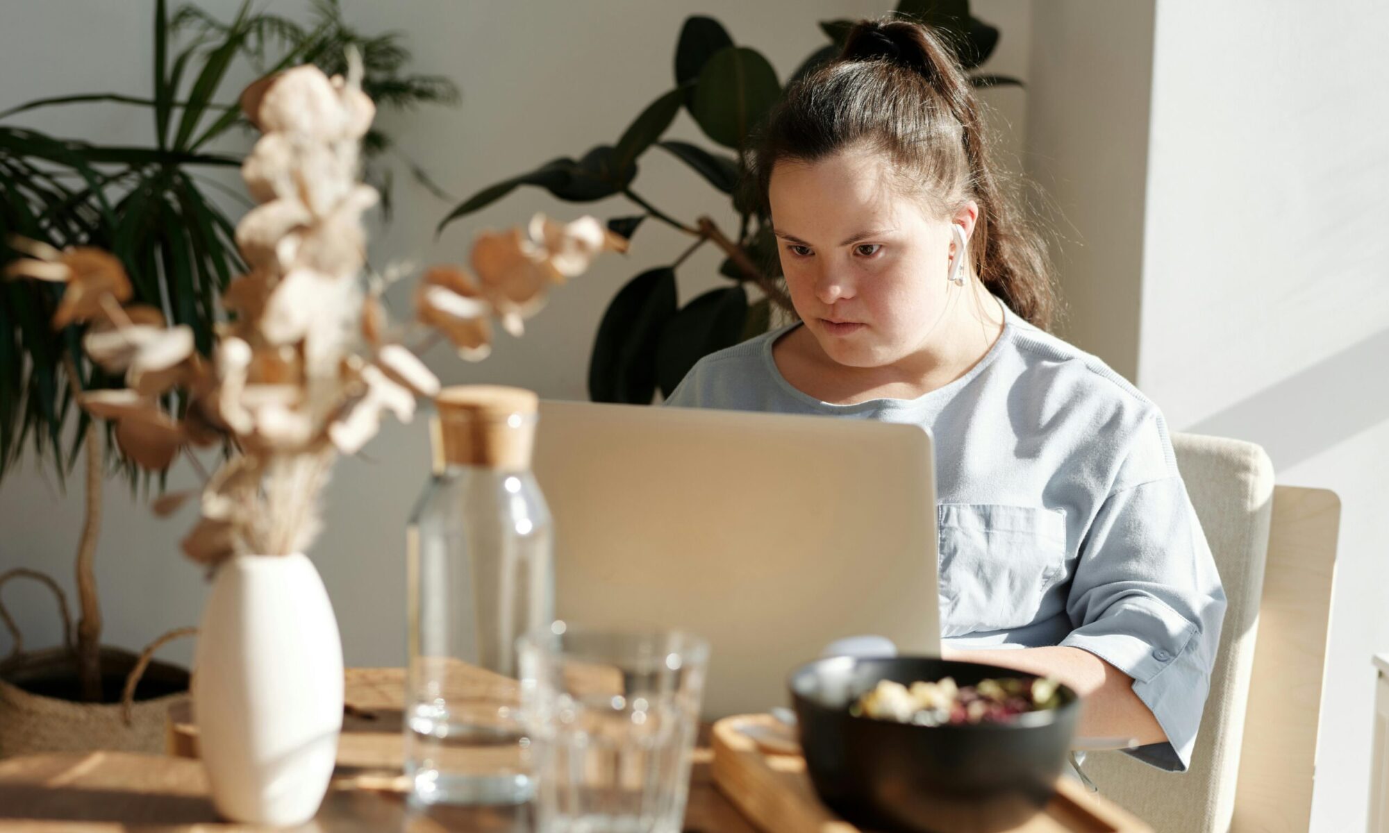Photo by Cliff Booth: https://www.pexels.com/photo/young-girl-using-laptop-inside-a-restaurant-4058222/