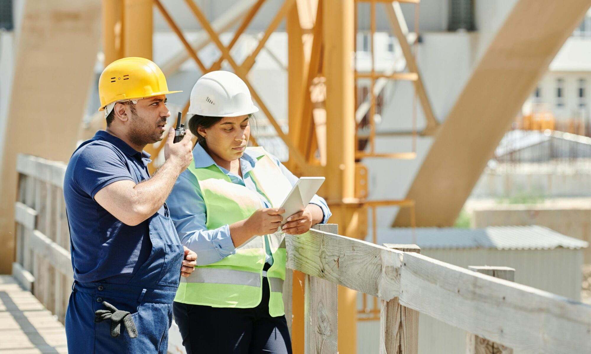 Photo by Mikael Blomkvist: https://www.pexels.com/photo/a-man-in-blue-shirt-using-a-walkie-talkie-while-standing-beside-the-woman-near-the-wooden-fence-8961131/