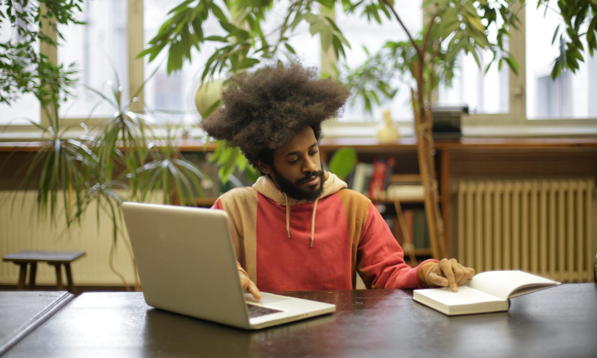 Photo by Andrea Piacquadio: https://www.pexels.com/photo/man-using-his-laptop-and-book-for-research-3966557/