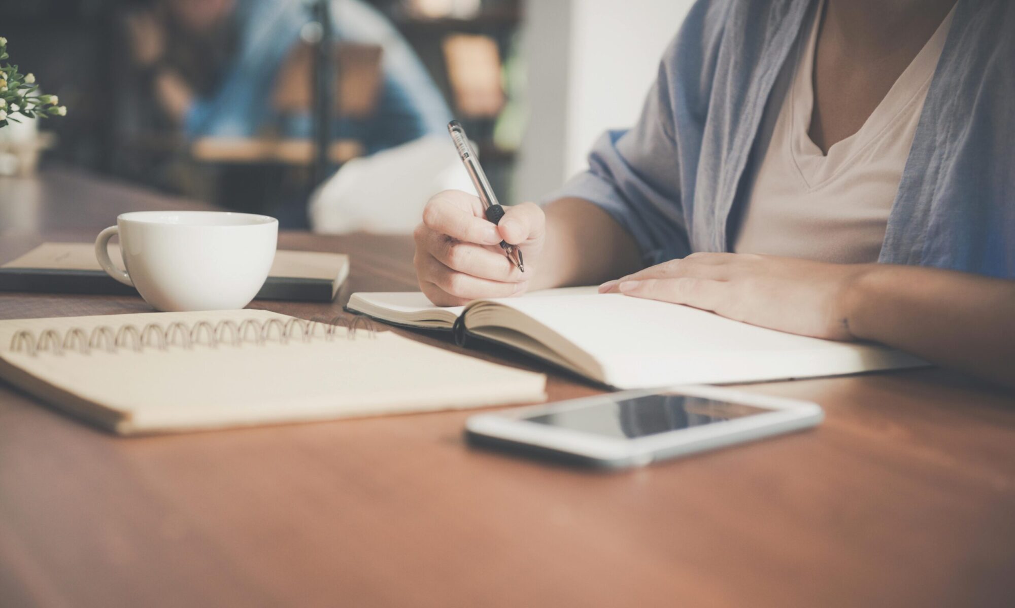 Photo by Tirachard Kumtanom: https://www.pexels.com/photo/woman-writing-on-a-notebook-beside-teacup-and-tablet-computer-733856/